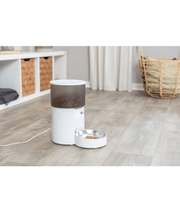 Trixie - TX-S Smart 3.0L Automatic Food Dispenser with pet food bowl on wooden floor.