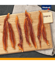 Vitakraft Pure Duck Filets, healthy dog treats with high protein, displayed on a wooden board.