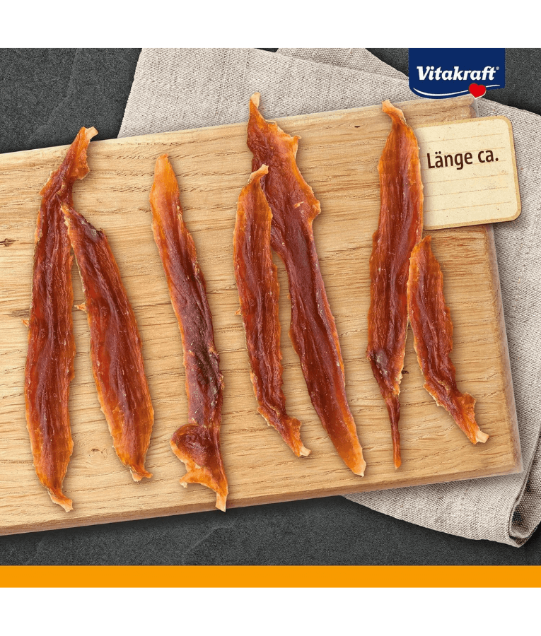 Vitakraft Pure Duck Filets, healthy dog treats with high protein, displayed on a wooden board.