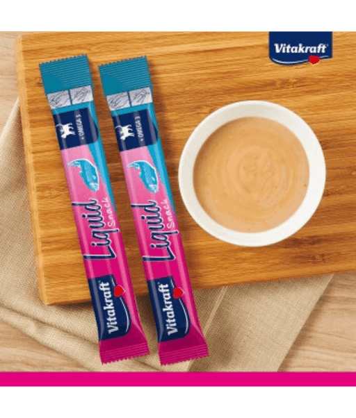 Vitakraft Liquid Snack Salmon sachets with creamy snack in bowl for cat skin and coat support.