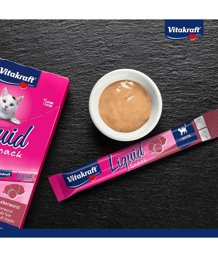 Vitakraft Liquid Snack Liver Sausage in sachet with creamy treat in bowl, low-calorie cat treat for all life stages.