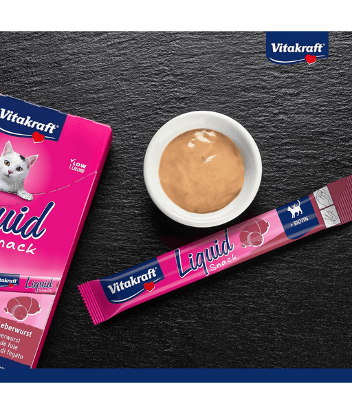 Vitakraft Liquid Snack Liver Sausage in sachet with creamy treat in bowl, low-calorie cat treat for all life stages.