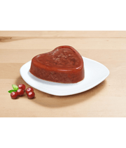 Vitakraft cat food for picky eaters in heart shape served on a plate with cranberries on the side.