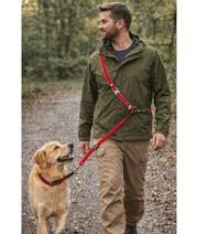 Duvo+ – EXPLOR West Duo Leash, Red, Woven Nylon, Adjustable & Hands-Free – XXL in use by dog owner walking a golden retriever.