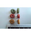 Assorted dry cat food pellets of various colors, representing balanced nutrition cat food, with ruler for size reference.